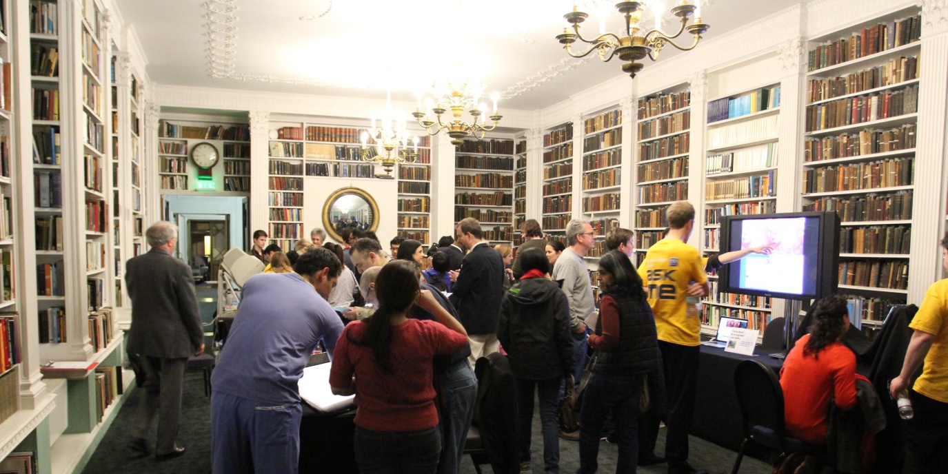 Researchers engaging with audience at interactive stations